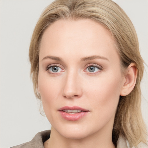 Joyful white young-adult female with long  brown hair and blue eyes