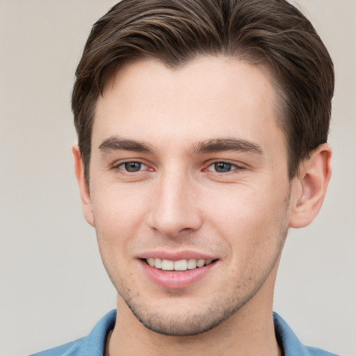 Joyful white young-adult male with short  brown hair and brown eyes