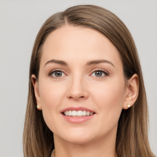 Joyful white young-adult female with long  brown hair and brown eyes