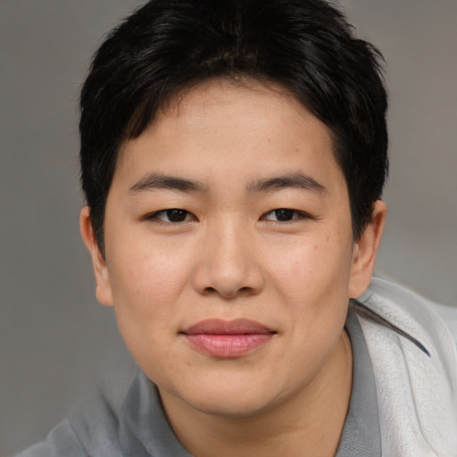 Joyful asian young-adult female with short  brown hair and brown eyes
