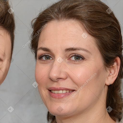 Joyful white adult female with medium  brown hair and brown eyes