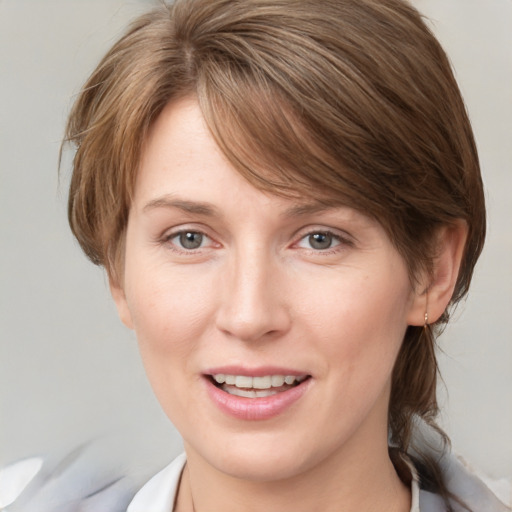 Joyful white young-adult female with medium  brown hair and blue eyes