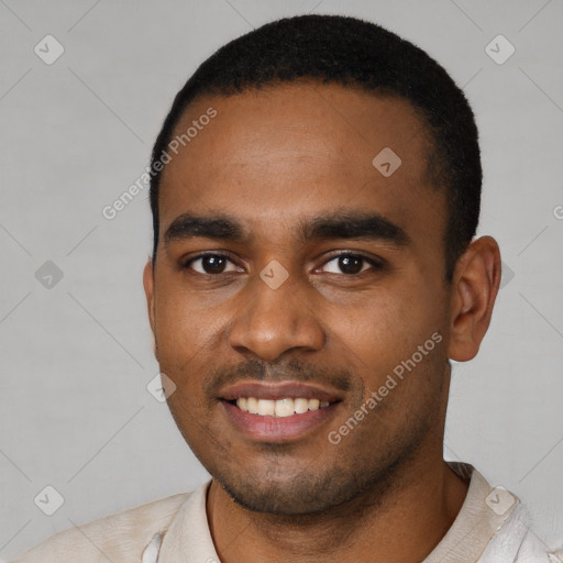 Joyful black young-adult male with short  black hair and brown eyes