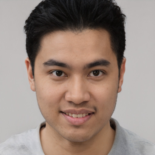 Joyful white young-adult male with short  black hair and brown eyes