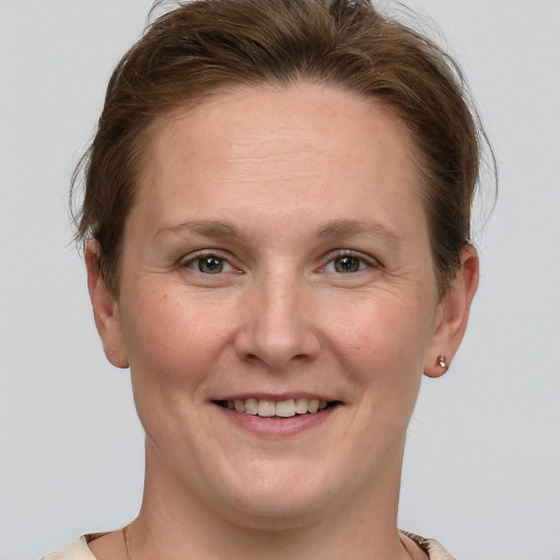 Joyful white adult female with short  brown hair and grey eyes