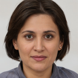 Joyful white adult female with medium  brown hair and brown eyes