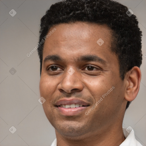 Joyful black young-adult male with short  black hair and brown eyes