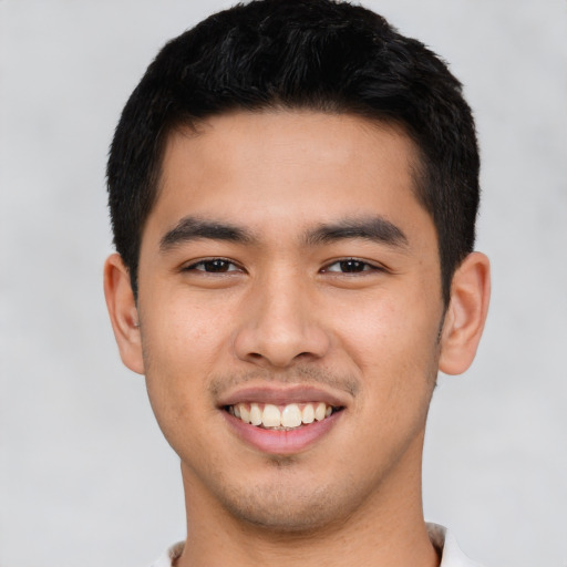 Joyful asian young-adult male with short  black hair and brown eyes