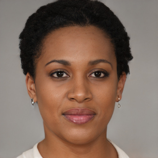 Joyful black young-adult female with short  brown hair and brown eyes