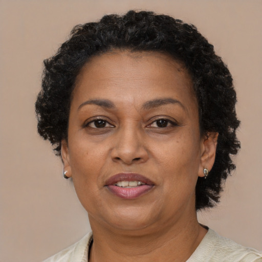 Joyful black adult female with short  brown hair and brown eyes