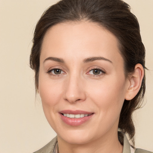 Joyful white adult female with medium  brown hair and brown eyes