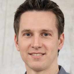 Joyful white adult male with short  brown hair and grey eyes