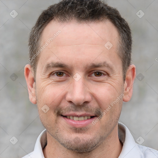 Joyful white adult male with short  brown hair and brown eyes