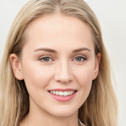 Joyful white young-adult female with long  brown hair and blue eyes