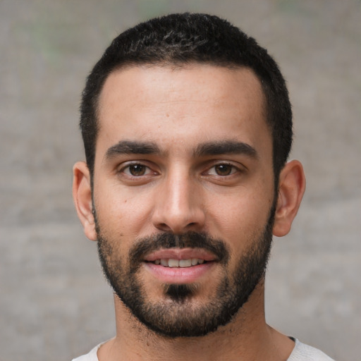 Joyful white young-adult male with short  black hair and brown eyes