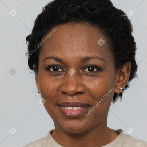 Joyful black adult female with short  black hair and brown eyes