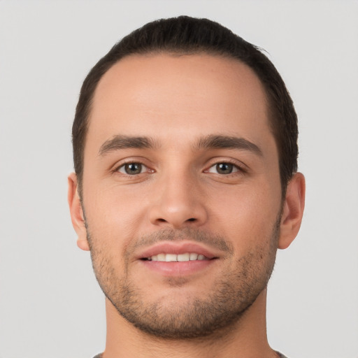 Joyful white young-adult male with short  brown hair and brown eyes