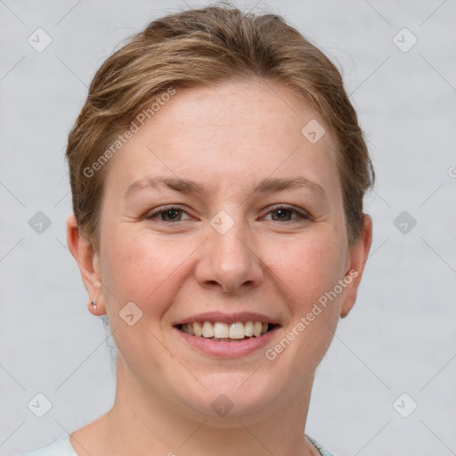 Joyful white young-adult female with short  brown hair and grey eyes