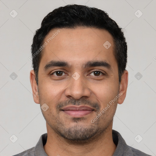 Joyful latino young-adult male with short  black hair and brown eyes