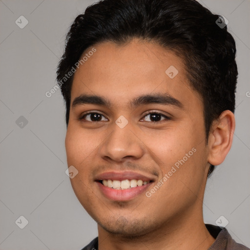 Joyful white young-adult male with short  black hair and brown eyes