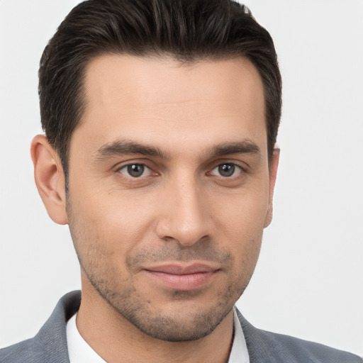 Joyful white young-adult male with short  brown hair and brown eyes