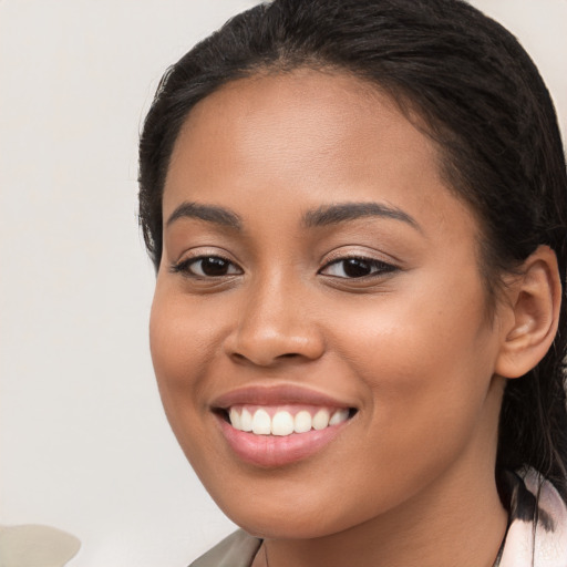 Joyful latino young-adult female with medium  brown hair and brown eyes