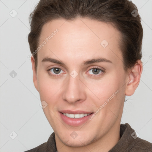 Joyful white young-adult female with short  brown hair and grey eyes