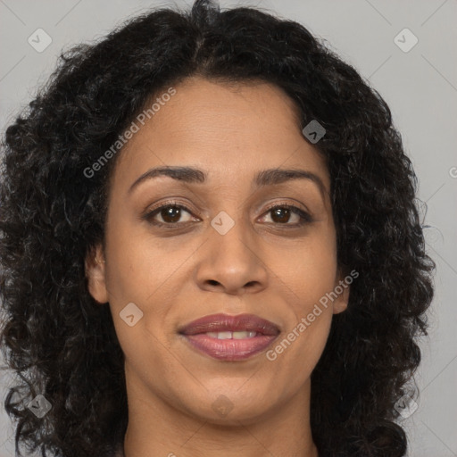 Joyful black adult female with long  brown hair and brown eyes