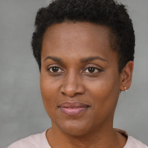 Joyful black young-adult female with short  brown hair and brown eyes