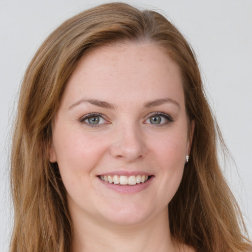 Joyful white young-adult female with long  brown hair and green eyes