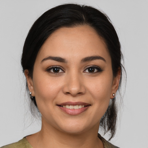 Joyful latino young-adult female with medium  brown hair and brown eyes