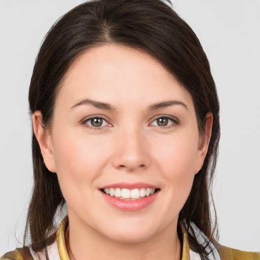 Joyful white young-adult female with medium  brown hair and brown eyes