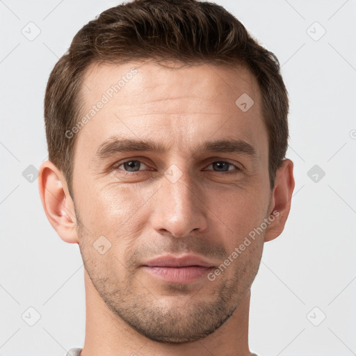 Joyful white young-adult male with short  brown hair and grey eyes