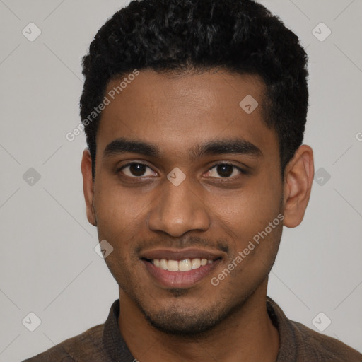 Joyful black young-adult male with short  black hair and brown eyes