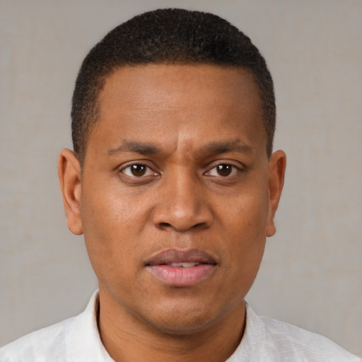 Neutral black adult male with short  brown hair and brown eyes