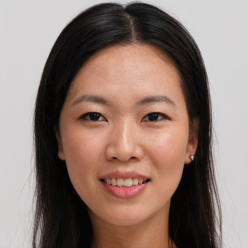 Joyful asian young-adult female with long  brown hair and brown eyes