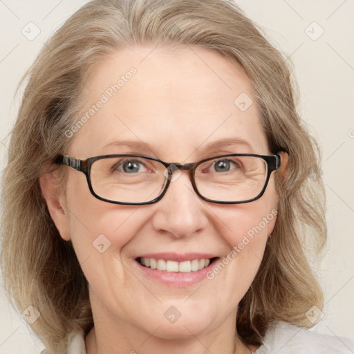 Joyful white adult female with medium  brown hair and blue eyes