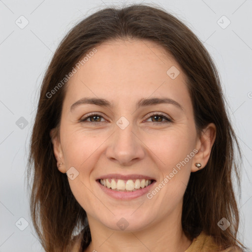 Joyful white adult female with long  brown hair and brown eyes