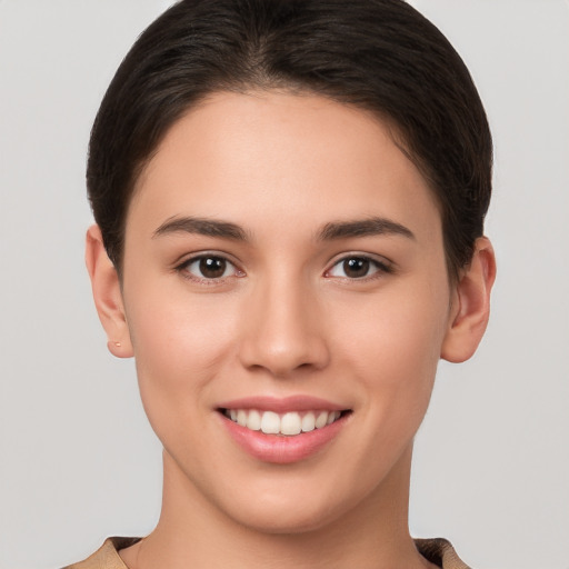 Joyful white young-adult female with short  brown hair and brown eyes