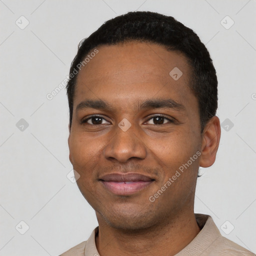 Joyful black young-adult male with short  black hair and brown eyes