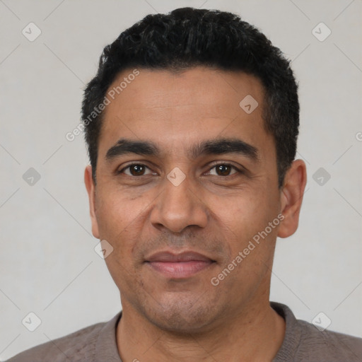 Joyful latino adult male with short  black hair and brown eyes
