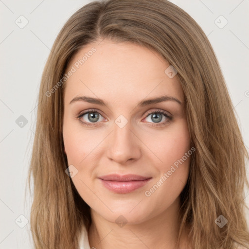 Joyful white young-adult female with long  brown hair and green eyes