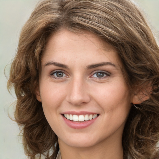 Joyful white young-adult female with long  brown hair and green eyes