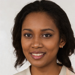 Joyful black young-adult female with medium  brown hair and brown eyes