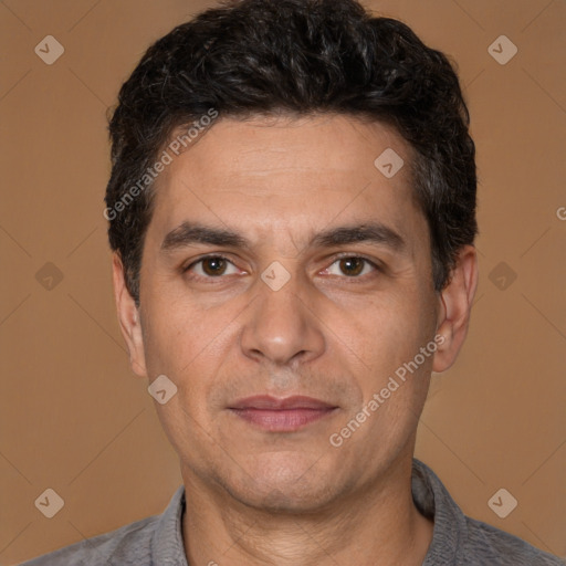 Joyful white adult male with short  black hair and brown eyes