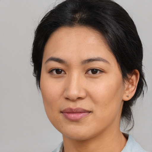 Joyful asian young-adult female with medium  brown hair and brown eyes