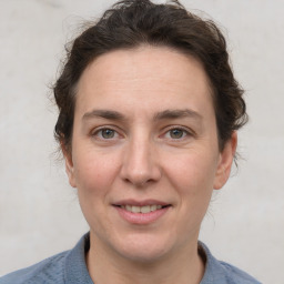 Joyful white adult female with short  brown hair and grey eyes