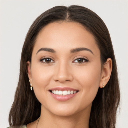 Joyful white young-adult female with long  brown hair and brown eyes