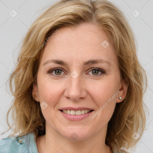 Joyful white adult female with medium  brown hair and blue eyes