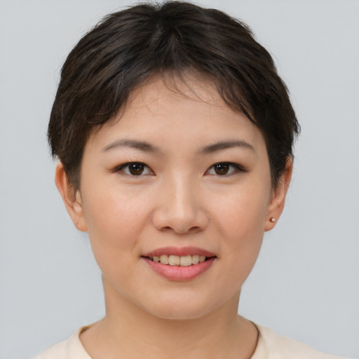 Joyful asian young-adult female with short  brown hair and brown eyes